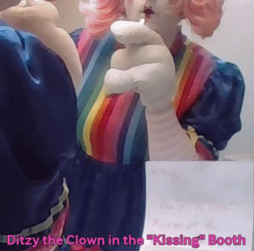 A Statue Of A Clown In A Rainbow Dress With The Words Ditzy The Clown In The Kissing Booth GIF