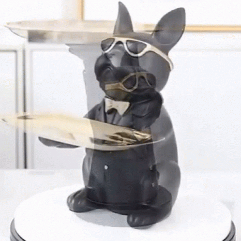 a statue of a dog wearing sunglasses and a suit holding a tray