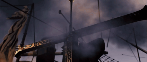 A Statue Of A Dragon Is Behind A Very Tall Pole That Says ' X ' GIF