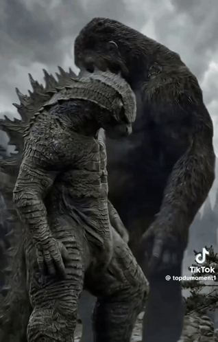 a statue of a gorilla standing next to a statue of a man with armor