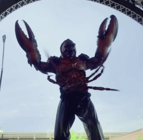 A Statue Of A Man Dressed As A Lobster With Huge Claws GIF