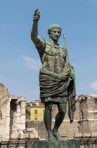 A Statue Of A Man Holding A Spear And A Sword GIF