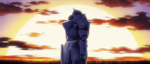 A Statue Of A Man In Armor Stands In Front Of A Sunset GIF