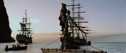 A Statue Of A Man Standing On Top Of A Ship In The Middle Of A Body Of Water GIF