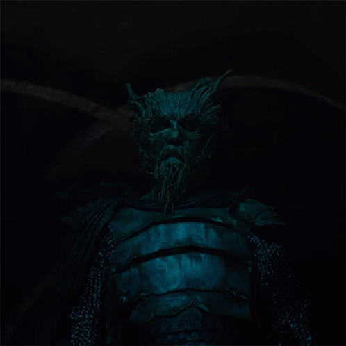 A Statue Of A Man With Horns And A Beard In The Dark GIF