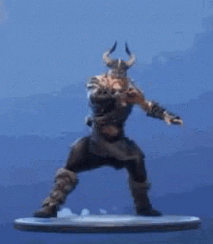 A Statue Of A Man With Horns Is Standing On A Platform . GIF