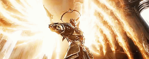 A Statue Of A Man With Wings Is Surrounded By Flames And Light GIF