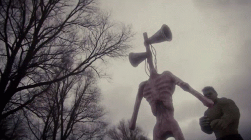 A Statue Of A Monster With A Megaphone In Its Head GIF