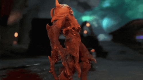 A Statue Of A Monster With Glowing Red Eyes And Sharp Teeth GIF