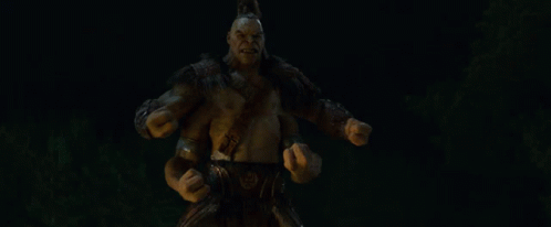 A Statue Of A Monster With His Mouth Open And Arms Outstretched In The Dark GIF