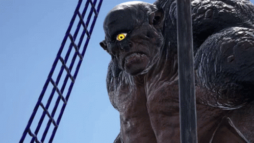 A Statue Of A Monster With Yellow Eyes Is Standing Next To A Ladder GIF