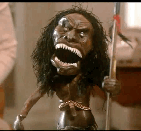 A Statue Of A Native American Holding A Spear With A Large Mouth . GIF