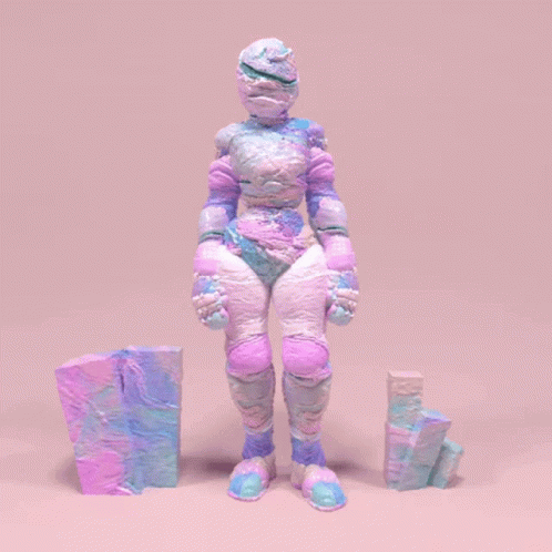 A Statue Of A Person With A Purple And Blue Costume GIF