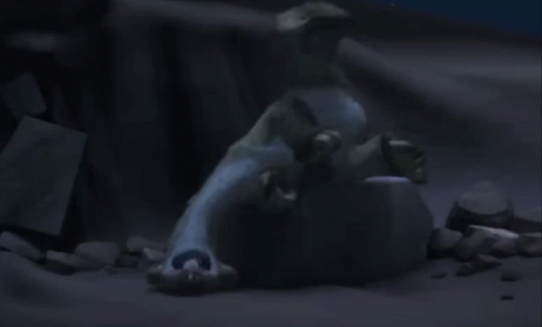 A Statue Of A Polar Bear Laying On Top Of A Rock In The Dark . GIF