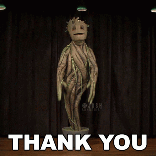 A Statue Of A Tree With The Words Thank You Behind It GIF