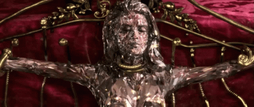 A Statue Of A Woman With A Necklace Around Her Neck GIF