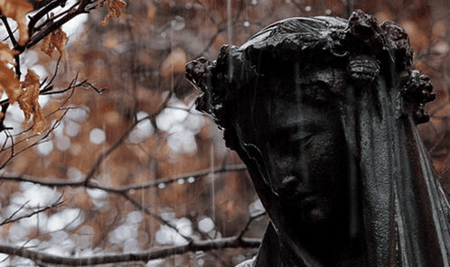 A Statue Of A Woman With A Veil On Her Head GIF