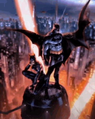 A Statue Of Batman And Catwoman Standing Next To Each Other In Front Of A City . GIF