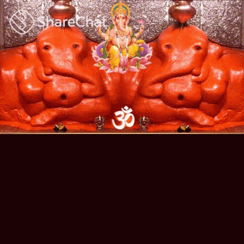 A Statue Of Ganesha And A Statue Of A Deity With An O Symbol GIF