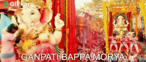 a statue of ganpati is being paraded through a crowd of people at a festival in india .