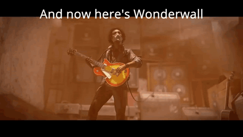 a statue with the words and now here 's wonderwall behind it
