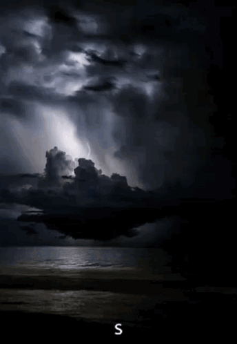 A Stormy Sky Over A Body Of Water With The Letter S On The Bottom Right GIF