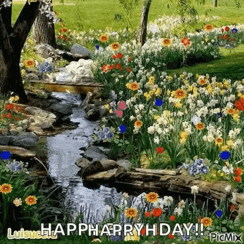 A Stream Runs Through A Garden Filled With Lots Of Flowers And Trees . GIF