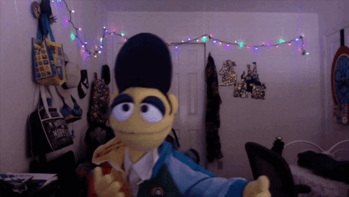 a stuffed animal in a room with a bag that says ' a ' on it
