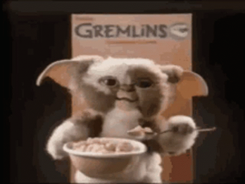 a stuffed animal is holding a bowl of cereal .