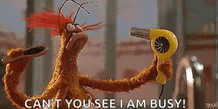 A Stuffed Animal Is Holding A Yellow Hair Dryer And Saying `` Can 'T You See I Am Busy '' . GIF