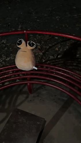 A Stuffed Animal Is Laying On Top Of A Red Swirl GIF