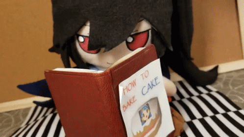 A Stuffed Animal Is Reading A Book About How To Bake A Cake GIF