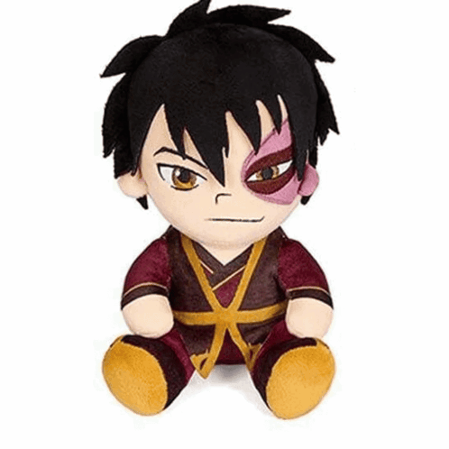 A Stuffed Animal Of A Boy With Black Hair And A Red Eye Is Sitting On A White Surface . GIF