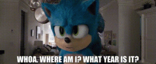 a stuffed animal of sonic the hedgehog is standing in a room and asking whoa where am i what year is it