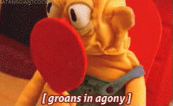 A Stuffed Animal Says Groans In Agony While Holding A Red Object In Its Mouth GIF