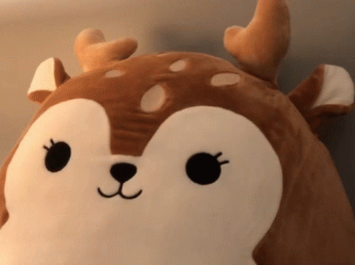 A Stuffed Animal That Looks Like A Deer With Antlers On It GIF