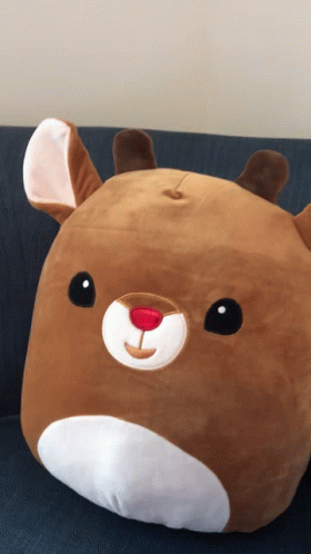 A Stuffed Animal That Looks Like A Reindeer With A Red Nose GIF