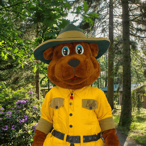 A Stuffed Animal Wearing A Hat And A Yellow Shirt That Says Bello GIF