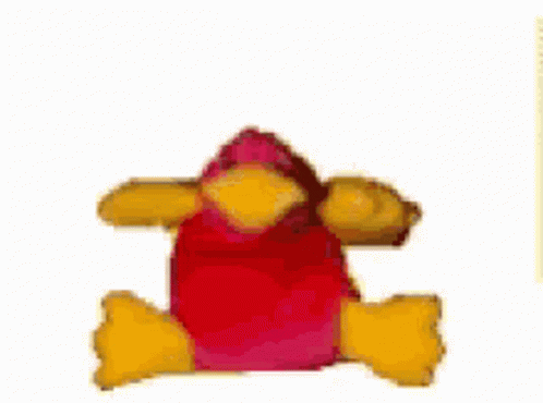 A Stuffed Animal With A Red Head And Yellow Arms Is Laying Down On A White Surface . GIF