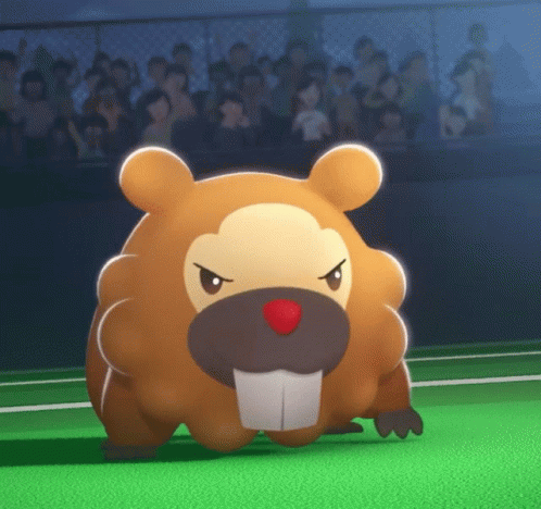A Stuffed Animal With A Red Nose Is Standing On A Green Field In Front Of A Crowd GIF