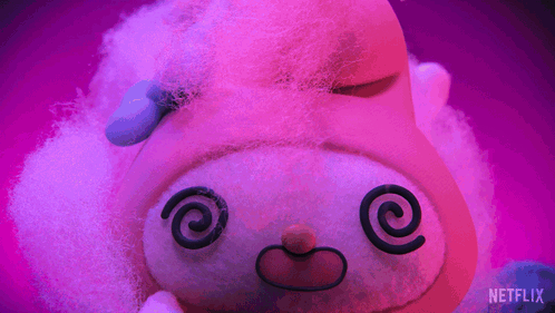 a stuffed animal with a swirl in its eyes is on a purple background with a netflix logo in the corner