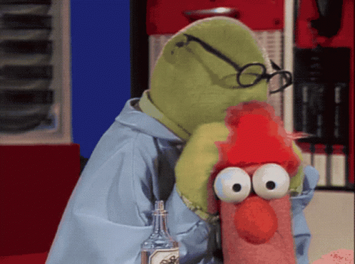 A Stuffed Animal With Glasses And A Red Hat Is Holding A Bottle GIF