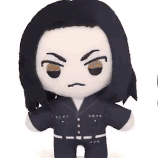 A Stuffed Animal With Long Black Hair And Brown Eyes Is Making A Funny Face . GIF