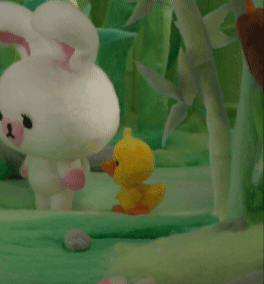 A Stuffed Bunny And A Stuffed Duck Are Standing Next To Each Other In The Grass GIF