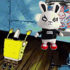 A Stuffed Bunny Wearing A Black Shirt With The Word Spongebob On It Is Standing Next To A Spongebob Doll GIF