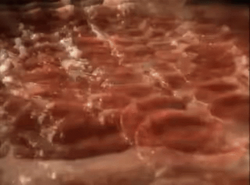 A Stuffed Crust Pizza Is Being Eaten With A Fork GIF