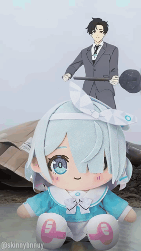 A Stuffed Doll With The Number 9 On It Sits In Front Of A Man In A Suit GIF