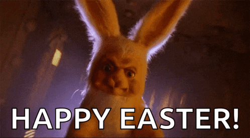 A Stuffed Easter Bunny Is Standing In The Dark And Says Happy Easter . GIF