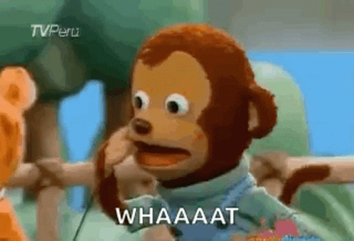 A Stuffed Monkey Is Making A Funny Face And Talking On A Cell Phone . GIF