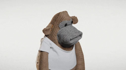 A Stuffed Monkey Wearing A White T-Shirt GIF